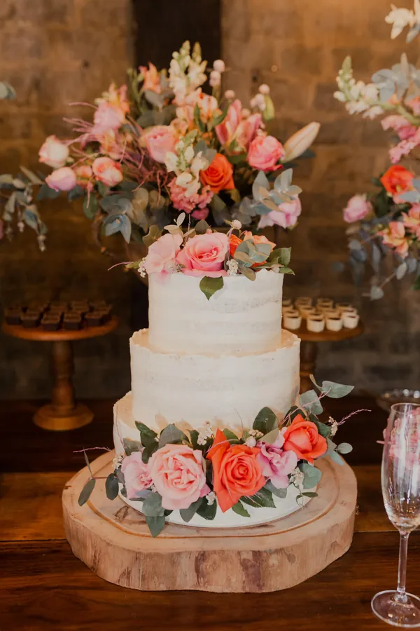 Três andares semi cobertos, com rosas e flores coloridas no topo e na base